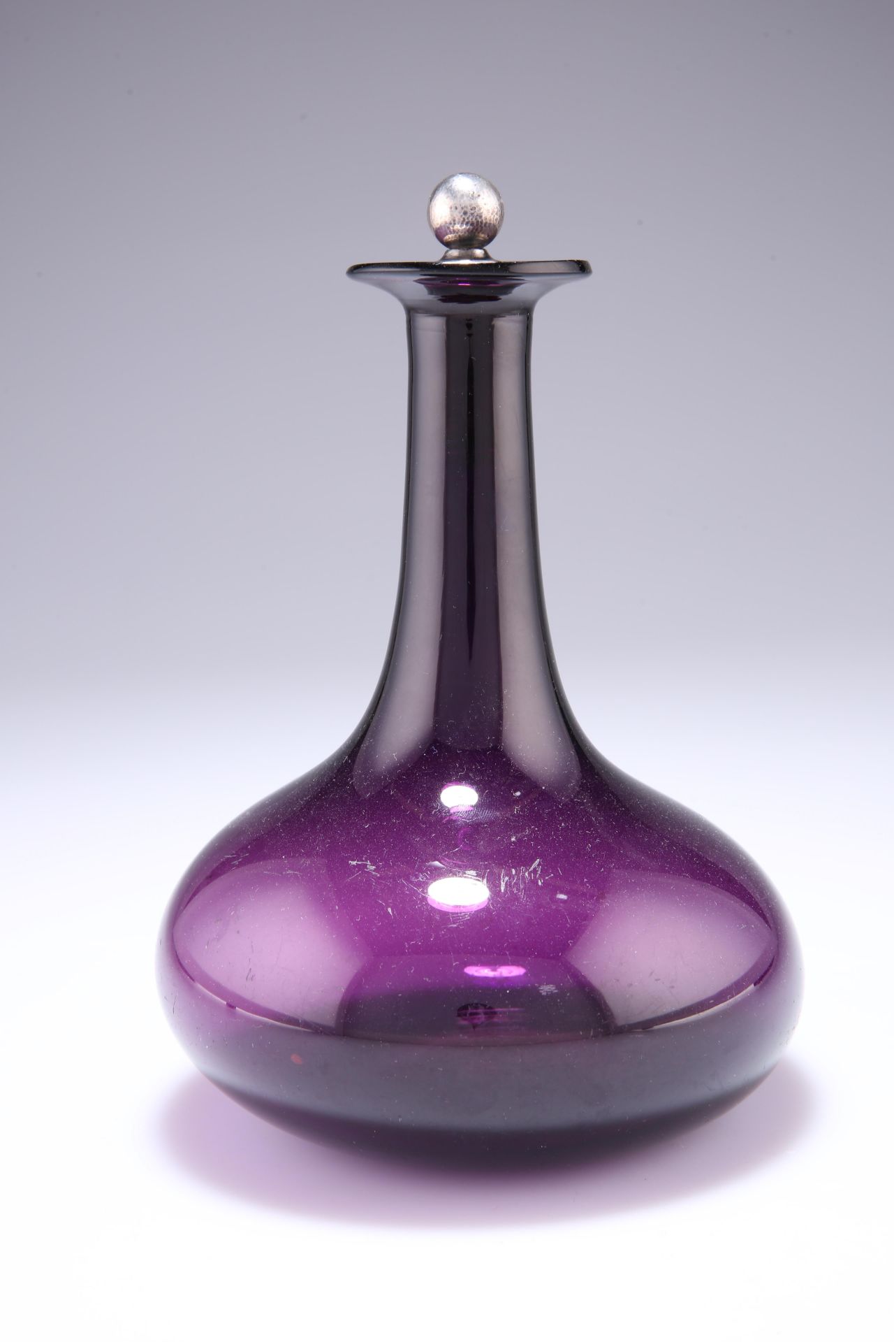 AN AMETHYST GLASS DECANTER, with hammered silver metal mounted cork stopper; A SQUARE-SECTION