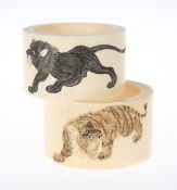 TWO IVORY NAPKIN RINGS, CIRCA 1900, circular, each carved and coloured, the first with two tigers,