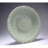 A LONGQUAN CELADON-GLAZED DISH, LATE MING DYNASTY, circular with scallop edge and ribs to the