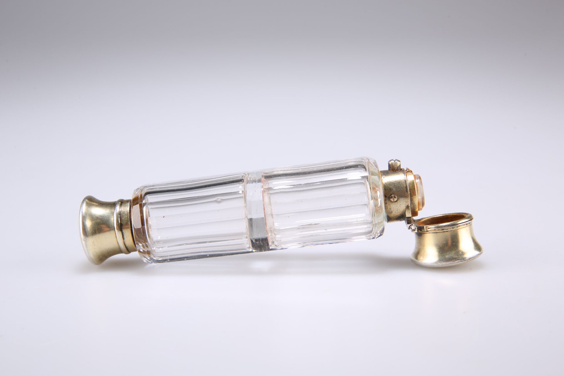 A LATE VICTORIAN DOUBLE-ENDED GLASS SCENT BOTTLE, by S. Mordan & Co, the faceted glass body with