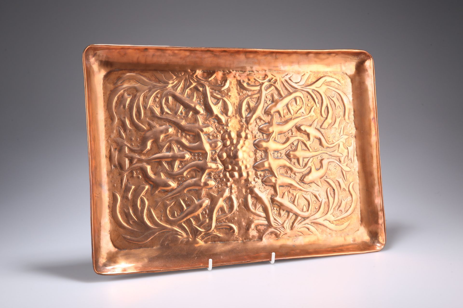 ATTRIBUTED TO NEWLYN, AN ARTS AND CRAFTS COPPER TRAY, rectangular, repousse with fish. 38cm by 26.