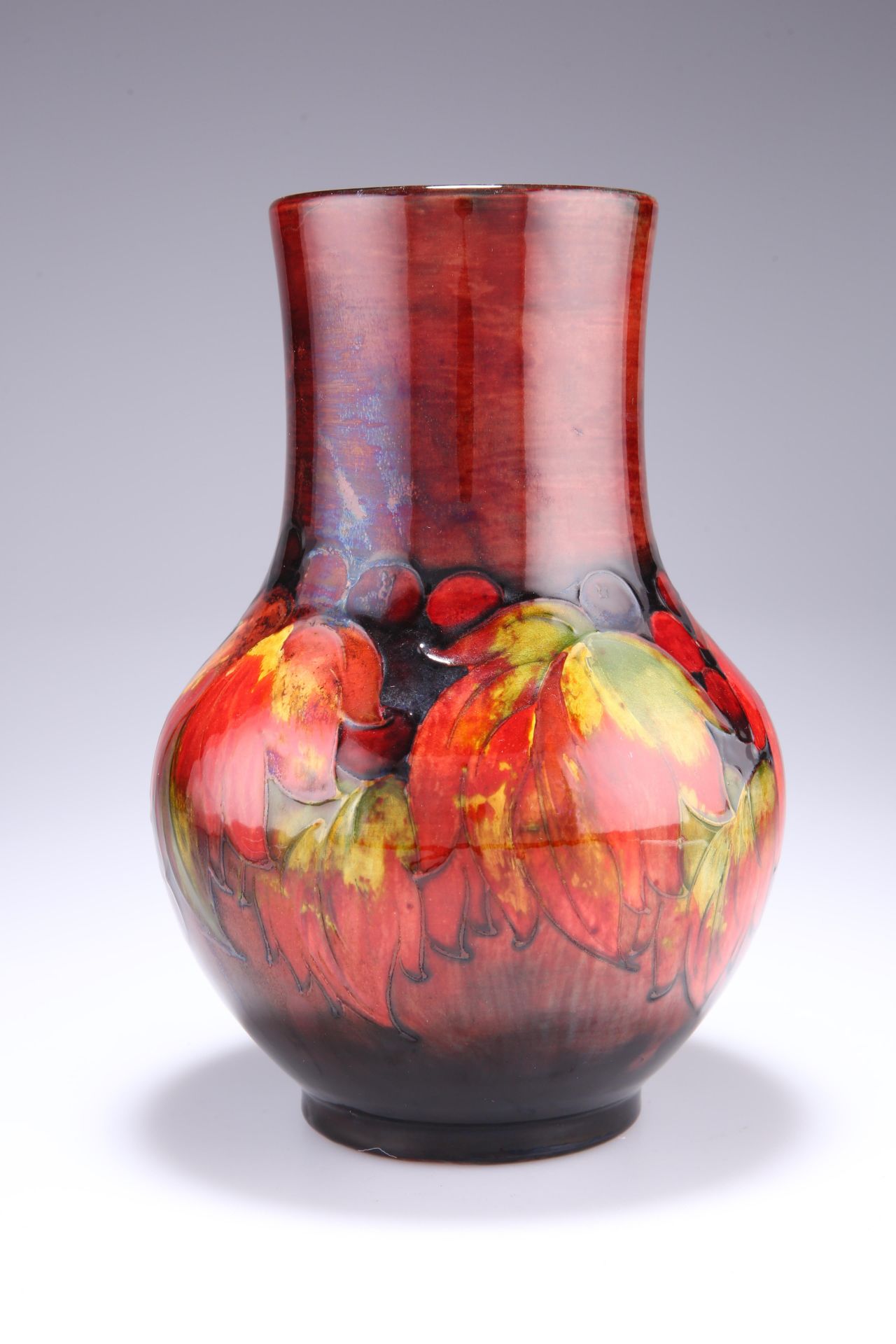 WILLIAM MOORCROFT A LARGE FLAMBE 'LEAF AND BERRY' VASE, of baluster form, Royal Warrant paper label,