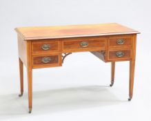 AN EDWARDIAN INLAID MAHOGANY WRITING DESK, the satinwood banded moulded rectangular top above five