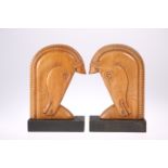 A PAIR OF ART DECO STYLE CARVED WOODEN BOOKENDS, each in the form of a stylised horse's head.