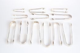 TWELVE PAIRS OF GEORGIAN AND VICTORIAN SILVER SUGAR TONGS, by various makers, of typical form. (