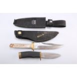 ~ AN AMERICAN BUCK HUNTING KNIFE, the 4-inch blade signed 'BUCK 692 U.S.A., with scabbard;