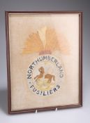 A NORTHUMBERLAND FUSILIERS NEEDLEWORK PANEL, framed. Overall 37.5cm by 29.5cm