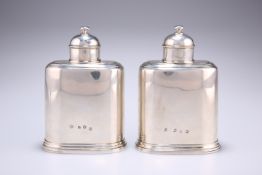 A PAIR OF GEORGE II SILVER TEA CADDIES, by John Newton, London 1739, of oval form with domed lids