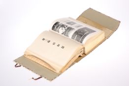 A JAPANESE BOOK WITH PAINTED CASE, the case gouache painted with scrolling foliage, containing