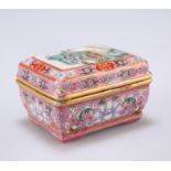 A SMALL CHINESE FAMILLE ROSE BOX AND COVER, rectangular, the cover painted with a village by a