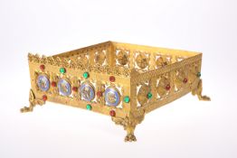 A GOTHIC REVIVAL 'JEWELLED' BRASS MISSAL STAND, CIRCA 1870, pierced square form, decorated to two