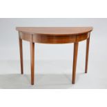 A GEORGE III MAHOGANY DEMI-LUNE SIDE TABLE with strung frieze and square section tapering legs. 72cm