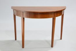 A GEORGE III MAHOGANY DEMI-LUNE SIDE TABLE with strung frieze and square section tapering legs. 72cm