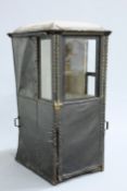 A MID 18TH CENTURY ENGLISH SEDAN CHAIR, covered in leather, with dome top, glazed sides and hinged