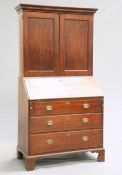 A GEORGE II OAK BUREAU BOOKCASE, the upper section with projecting dentil cornice above a pair of