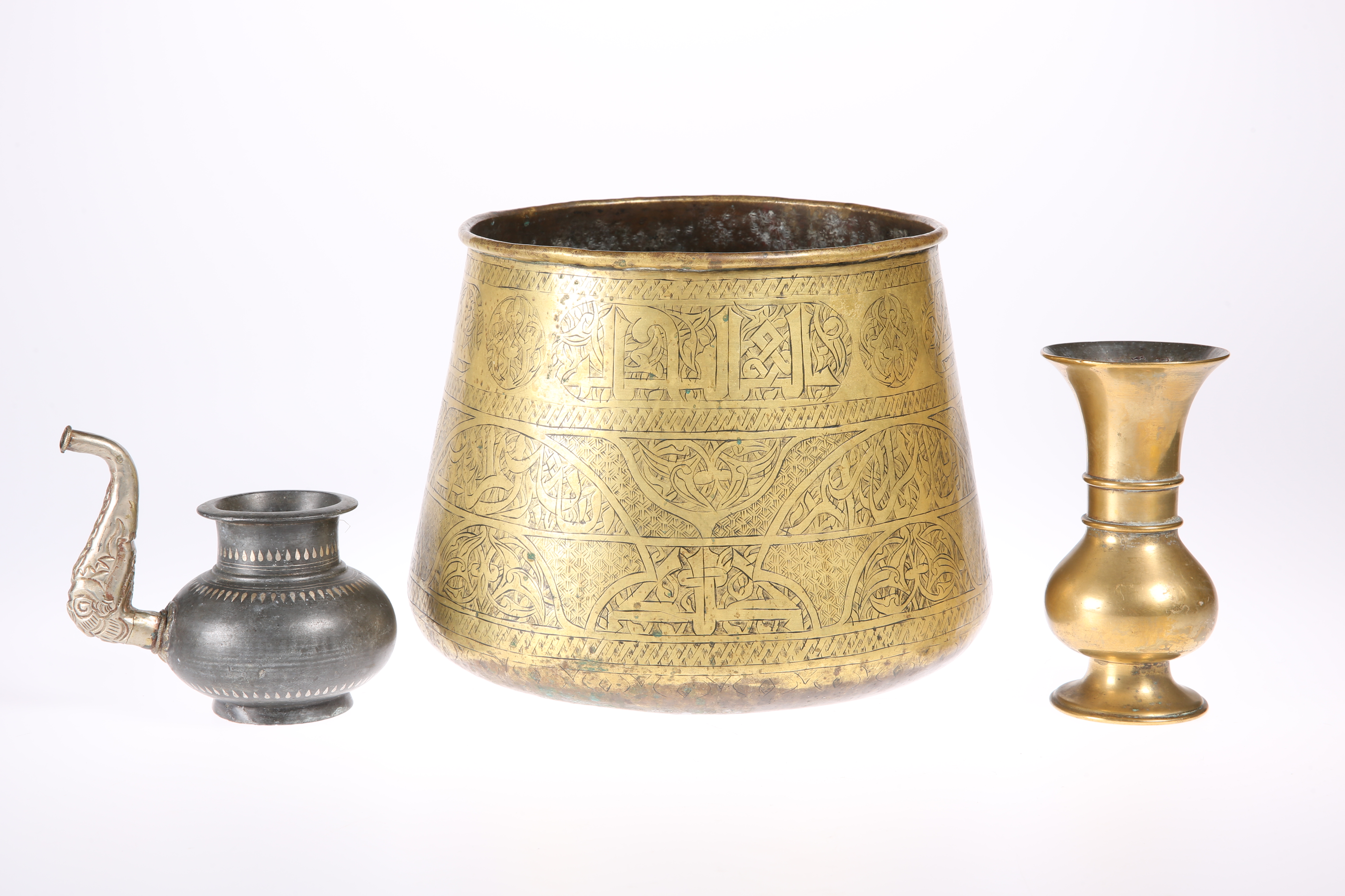 A LARGE ISLAMIC BRONZE BOWL, decorated with script; together with two other Islamic items, A POT