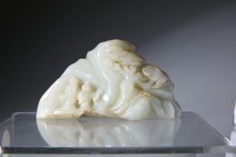 A CHINESE JADE CARVING, depicting mountains with two men walking beneath trees, with a seated deer