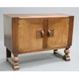 AN ART DECO OAK SIDEBOARD fitted with a pair of doors flanked by reeded pilasters. 90.5cm high,
