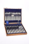 A SET OF TWELVE GEORGE V DESSERT KNIVES AND FORKS, by Atkin Brothers, Sheffield 1930, with mother-