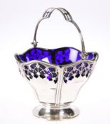 A GEORGE V SILVER SWING-HANDLE SUGAR BASKET, by Mappin & Webb Ltd, Birmingham 1912, with pierced