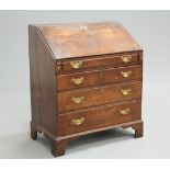 AN 18TH CENTURY OAK SLANT FRONT BUREAU, the hinged slope opening to reveal a fitted interior,