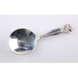 A GEORG JENSEN SILVER CADDY SPOON, c.1930s, stamped Sterling Denmark, the circular bowl with