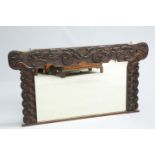 A LARGE ARTS AND CRAFTS CELTIC REVIVAL CARVED OAK OVERMANTEL MIRROR, CIRCA 1900, signed FW and dated