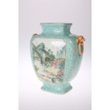A CHINESE TURQUOISE GROUND VASE, painted verso and recto with a landscape panel in a famille rose