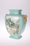 A CHINESE TURQUOISE GROUND VASE, painted verso and recto with a landscape panel in a famille rose