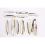 A QUANTITY OF FRUIT KNIVES WITH MOTHER-OF-PEARL FACE PLATES, some with hallmarked silver blades. (