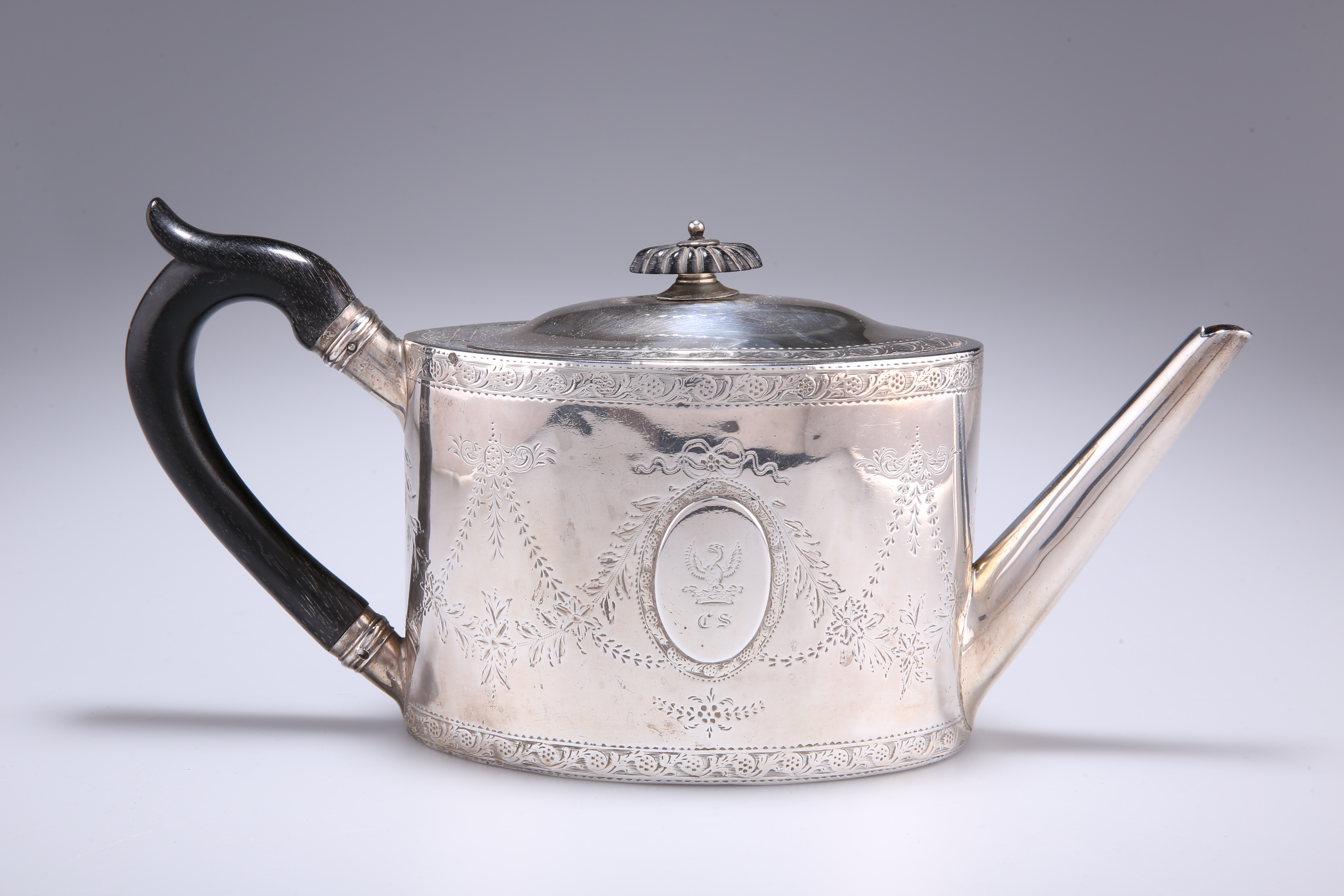 A GEORGE III SILVER TEAPOT, by William Vincent, London 1786, oval, with bright-cut decoration,