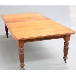 A 19TH CENTURY MAHOGANY WIND-OUT DINING TABLE, the moulded top with canted corners, raised on reeded