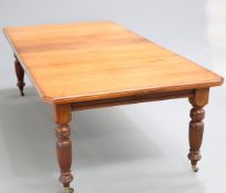 A 19TH CENTURY MAHOGANY WIND-OUT DINING TABLE, the moulded top with canted corners, raised on reeded