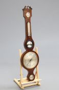 AN EARLY 19TH CENTURY STRING-INLAID MAHOGANY BANJO PATTERN BAROMETER, with silvered dials and swan-