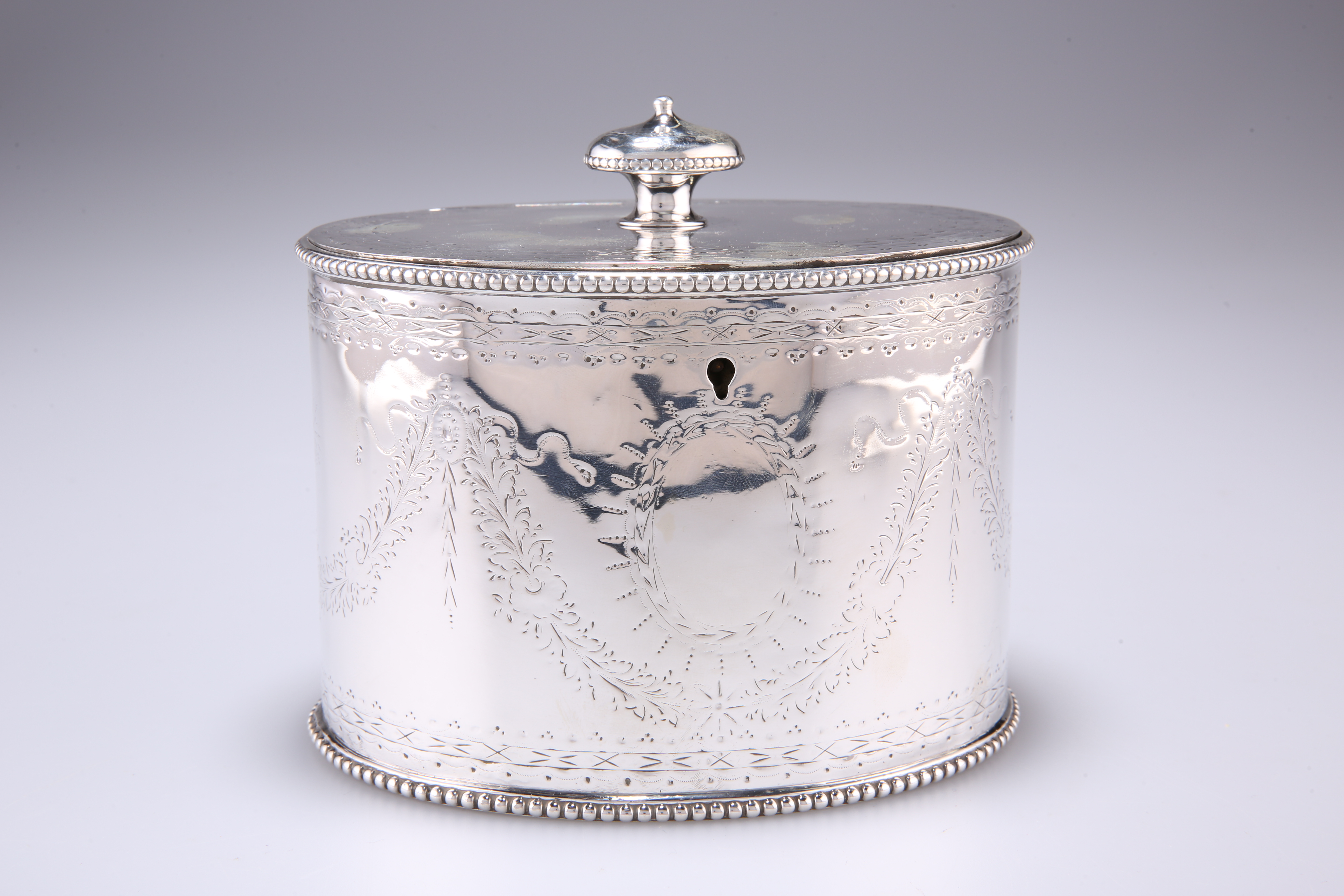 A VICTORIAN SILVER OVAL TEA CADDY, by Robert Harper, London 1866, of oval form with hinged lid and