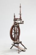 A GEORGIAN MAHOGANY SPINNING WHEEL of characteristic form. 105cm high