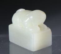 A CHINESE CARVED JADE SEAL, depicting a seated dog. 3cm by 3.5cm.