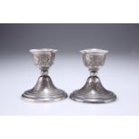 A PAIR OF RUSSIAN SILVER DWARF CANDLESTICKS, EARLY 20TH CENTURY, of squat form with stepped circular