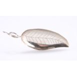 A GEORGE IV SILVER CADDY SPOON, possibly Joseph Taylor, Birmingham 1823, the leaf pattern bowl