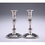 A MATCHED PAIR OF VICTORIAN SILVER TAPER STICKS, makers marks rubbed, Sheffield 1893 and 1898, of