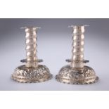 A PAIR OF VICTORIAN CHASED CANDLESTICKS, by George Fox, London 1880, each with removable drip tray