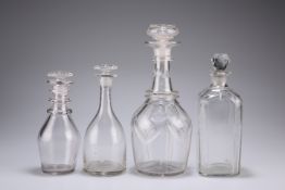 A GROUP OF FOUR GEORGIAN AND VICTORIAN GLASS DECANTERS, the first with panel-cut shoulder and