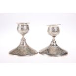 A PAIR OF PERSIAN SILVER CANDLESTICKS, CIRCA 1900, of squat circular form. 9.5cm, 8.4 troy ounces