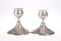 A PAIR OF PERSIAN SILVER CANDLESTICKS, CIRCA 1900, of squat circular form. 9.5cm, 8.4 troy ounces