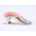 A SILVER SHOE PIN CUSHION, hallmarked Sterling, in the form of a dress shoe with velvet lined pin