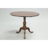 A LARGE GEORGE III OAK TILT-TOP TRIPOD TABLE, the circular top raised on a turned stem continuing to