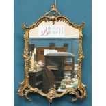 A ROCOCO STYLE GILT-COMPOSITION MIRROR, with acanthus moulded frame. 86.5cm high, 61.5cm wideThe