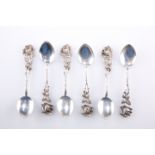 A SET OF SIX CONTINENTAL SILVER METAL COFFEE SPOONS, with moulded rose head handles, stamped '