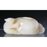 A CHINESE JADE BRUSH WASH, carved with a child and cat either side of the vessel. 2cm by 6cm.