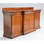 AN EARLY 19TH CENTURY MAHOGANY BREAKFRONT SIDE CABINET, with two pairs of cupboard doors